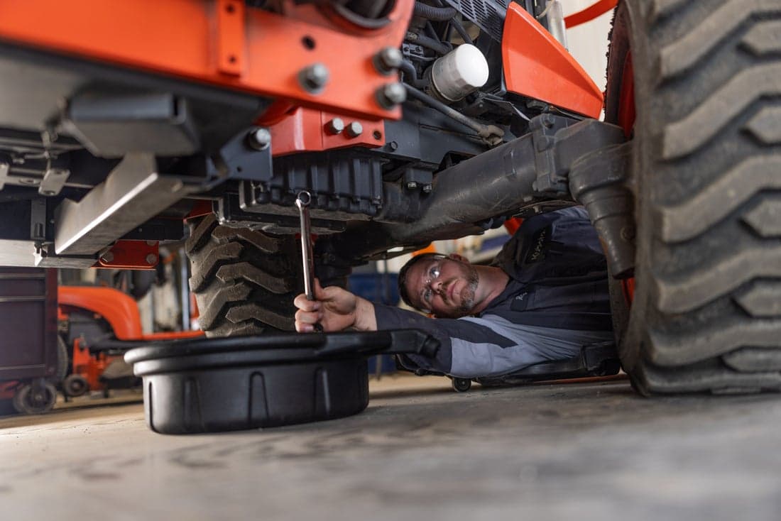 Technician working on tractor