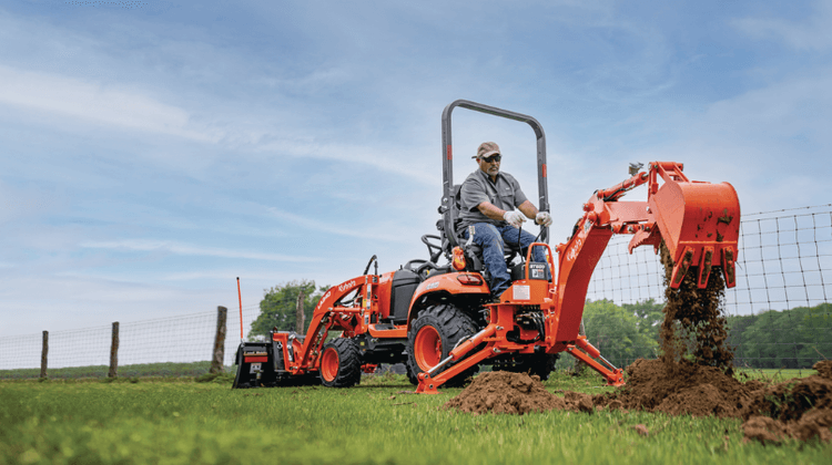 Man using backhoe on tractor
