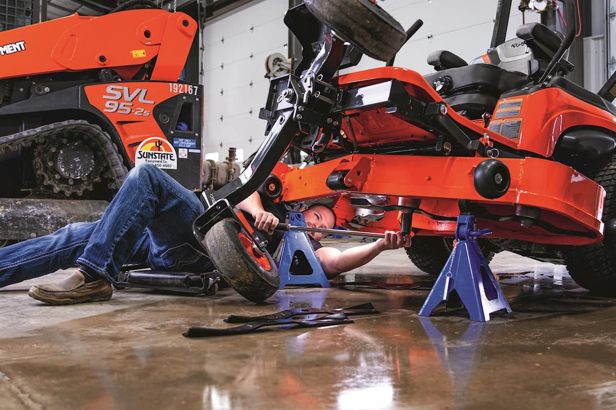 Technician working on Mower