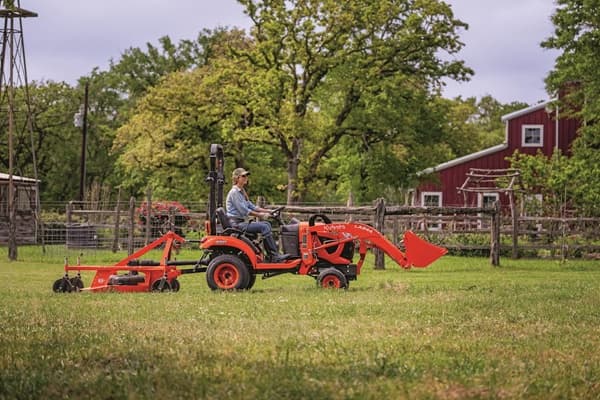 Woman mowing lawn with rear mower