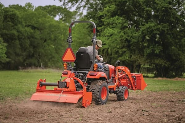 Man using box blade with tractor