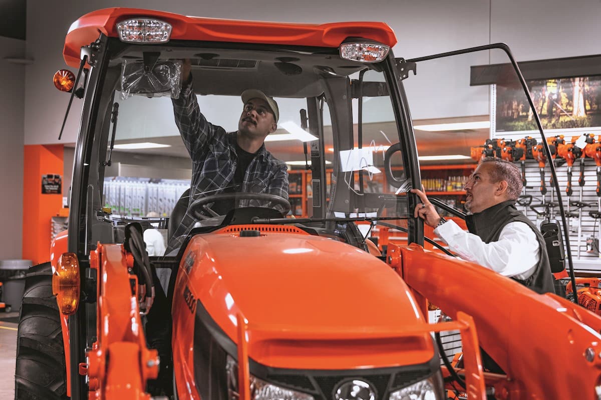 Customer looking at a tractor at a dealership