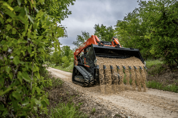 Track Loader dumping gravel onto driveway