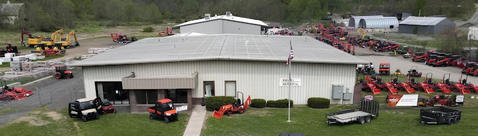Kubota dealer near Middletown, NY, with Marshall Machinery's building and lot of Kubota tractors, excavators and utility vehicles